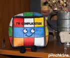 Colorful plush toy with a face and text 'I'm Complicated!' on a wooden surface, branded 'punchkins'.