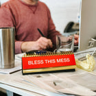 Daily Desk Plaque - Desktop Flip Book - 50 Fun Phrases on a messy table