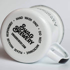 White mug with 'Swag Brewery' branding and text on a light gray background