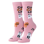 Pink socks with cat illustrations and text on a white background