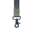 Green webbing strap with a metal clasp on a white background
