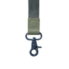 Green webbing strap with a metal clasp on a white background