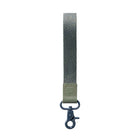 A vertical woven strap keychain or bag clip in muted gray and olive green, featuring a dark blue metal swivel clasp at the bottom, shown on a plain light gray background.