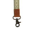 Green strap with brown leather clasp on a white background