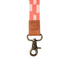 Strap with checkered pattern and brown leather buckle on a white background