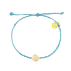 Blue braided bracelet with gold charm on a white background