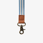 Striped lanyard with a brown leather patch and metal clasp on a white background