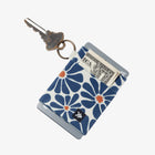 Keychain with blue floral pattern, key, and card holder on a white background