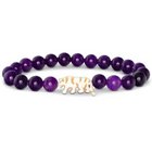 A purple beaded stretch bracelet featuring a central carved elephant charm with orange stripes, displayed on a clean white background.