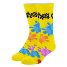 A pair of bright yellow crew socks featuring a colorful pattern of geometric puzzle-piece shapes in blue, orange, purple, and red, with the word 'fishers' printed in black across the top.