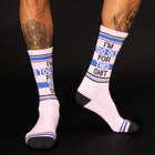 White socks with blue and black text worn by a person on a black background