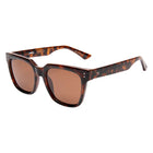 Sunglasses with tortoiseshell frame and brown lenses on a white background