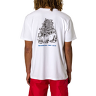 A person shown from the back wearing a white short-sleeve T-shirt with a large black illustrated graphic on the back and red shorts, against a plain light gray studio background.