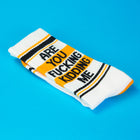 Sock with text 'ARE YOU FUCKING KIDDING ME?' on a blue background