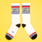White socks with 'Exhausted American' text on a yellow background