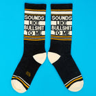 Black socks with text 'SOUNDS LIKE BULLSHIT TO ME' on a blue background