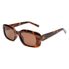 Tortoiseshell sunglasses with brown lenses on a white background