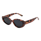 Sunglasses with tortoiseshell frame and dark lenses on a white background