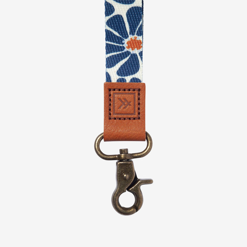 Lanyard with floral pattern and brown leather clip on a white background