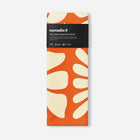 Nomadix towel with orange and beige design on a white background