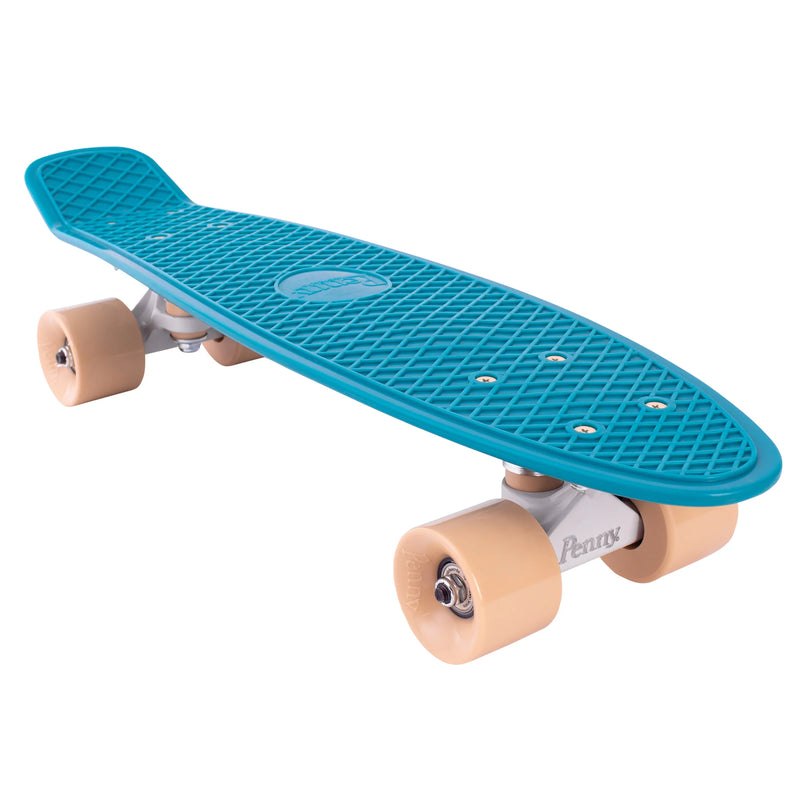 A side-angle view of a teal Penny skateboard with sand-colored wheels, showcasing its compact design and smooth-rolling wheels.