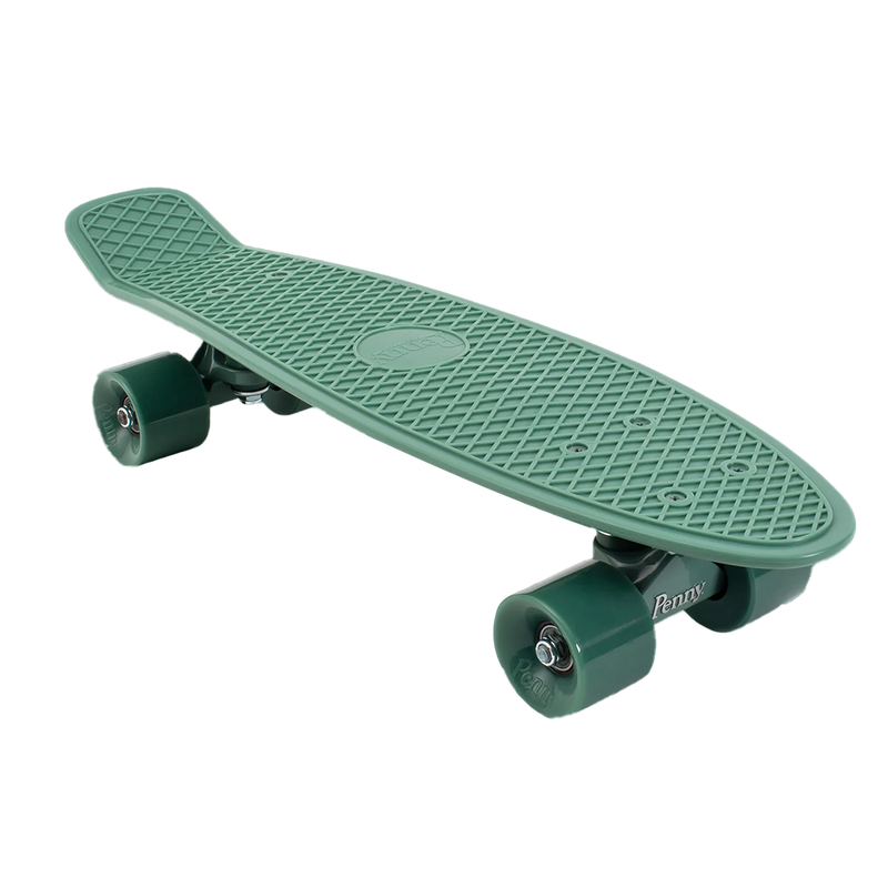 A side-angle view of a green Penny skateboard with green wheels, showcasing its compact design and smooth-rolling wheels.