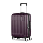 A hard-shell spinner suitcase in a deep plum purple color with vertical grooves, featuring a telescopic silver handle, black accents, and four multi-directional wheels, shown on a plain white background.