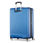 A blue hard-shell spinner suitcase with vertical ribbing, an extended telescopic handle, and four wheels, shown on a plain white background.