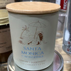 Candle with a wooden lid featuring a beach scene and 'Santa Monica, California' text.