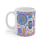Colorful mug with a Ferris wheel, ice cream cone, and other icons on a white background