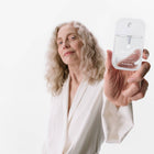 Model holding Beach Coco Power Mist Hydrating Hand Sanitizer