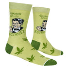 Green socks with marijuana leaf patterns and text on a white background