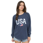 Woman wearing a navy blue sweatshirt with 'USA' and an American flag design on a white background