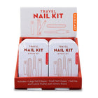 Display of travel nail kits with packaging on a white background