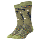 A pair of crew socks in olive green with a dark blue scorpion design and geometric border patterns in orange, cream, and dark gray, shown on a white background.