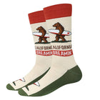 A pair of crew socks featuring a California-themed design with a brown grizzly bear carrying a surfboard, the word 'CALIFORNIA' in brown, and 'DREAMIN'' in red. The socks have a cream-colored body, a red cuff, and a dark green toe and heel.