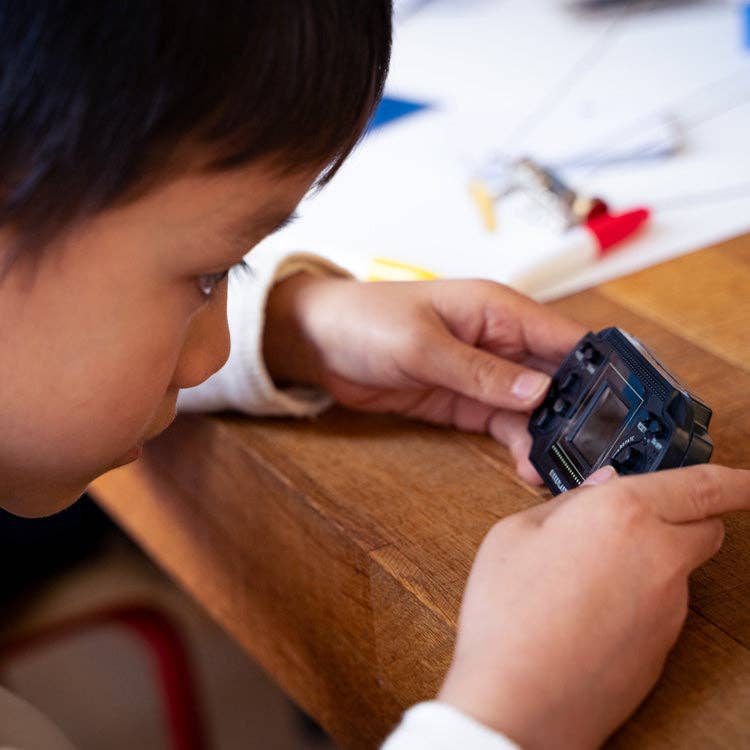Child playing Retro Arcade Game