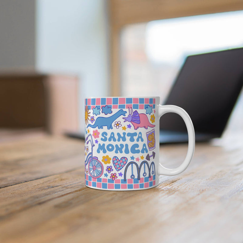 Colorful mug with 'Santa Monica' design on a wooden surface