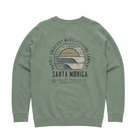 A sage green crewneck sweatshirt shown from the back, featuring a large circular graphic print with a sunset design and the text 'PACIFIC CREATIONS MANUFACTURING COMPANY' and 'SANTA MONICA'.