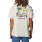 A man wearing a cream-colored t-shirt, viewed from the back. The shirt features a large graphic print of a beach scene with a palm tree, a yellow sun that reads 'Kailua Shores', and a campfire with the text 'Easy does it since 1954'.