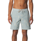 A man wearing light blue board shorts with a white surf-themed graphic print and a white drawstring, shown from the waist down against a light gray studio background.