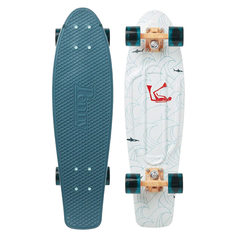 Top and bottom view of a Penny skateboard. The top is textured in teal blue with 'Penny Australia' embossed. The bottom features a white deck with wave patterns, a red diver graphic, and small black shark illustrations. The skateboard has teal translucent wheels and light wood-colored trucks.