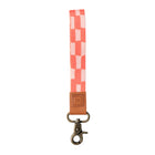 Checkered strap with a brown leather buckle on a white background
