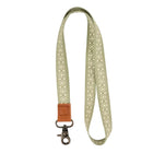 Light green lanyard with a brown leather strap on a white background