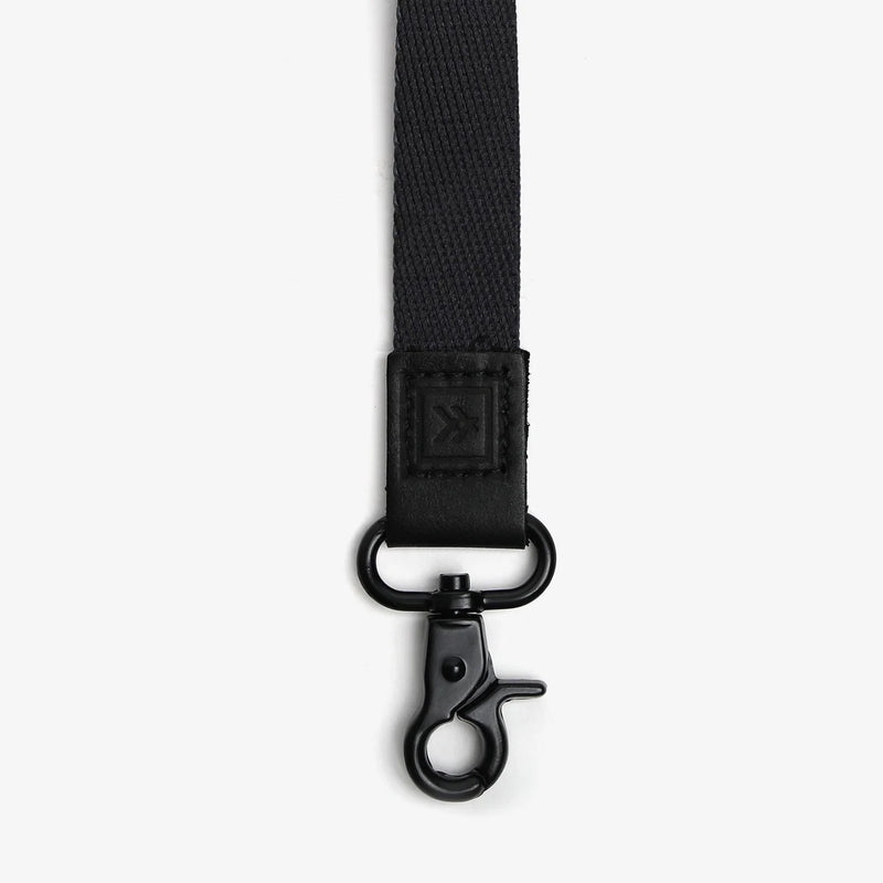 Black strap with a clasp on a white background