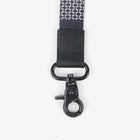 Black strap with metal clasp on a white background