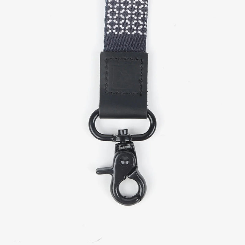 Black strap with metal clasp on a white background