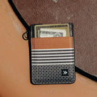 Striped cardholder with money on a textured surface
