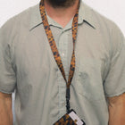 Person wearing a green striped shirt with a leopard print lanyard and phone holder.